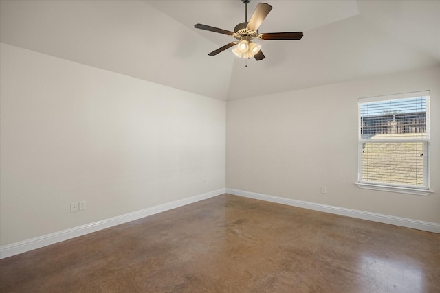 unfurnished room with ceiling fan, concrete flooring, and vaulted ceiling