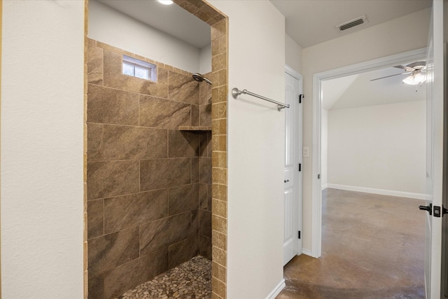 bathroom with ceiling fan, a tile shower, and concrete flooring