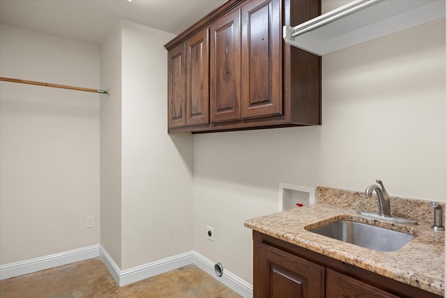 clothes washing area with cabinets, hookup for a washing machine, hookup for an electric dryer, and sink