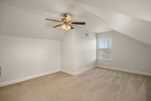 bonus room with ceiling fan, light carpet, and vaulted ceiling