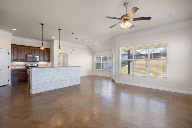 kitchen featuring appliances with stainless steel finishes, decorative light fixtures, and ornamental molding