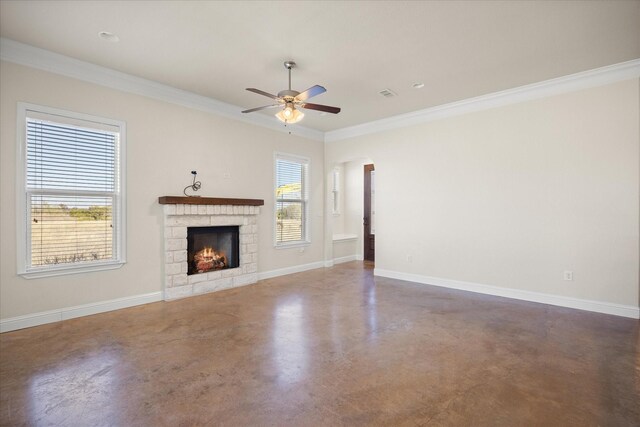 unfurnished living room with a stone fireplace, ceiling fan, and ornamental molding