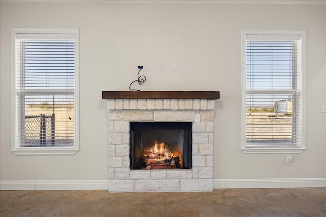 interior details featuring a stone fireplace and carpet