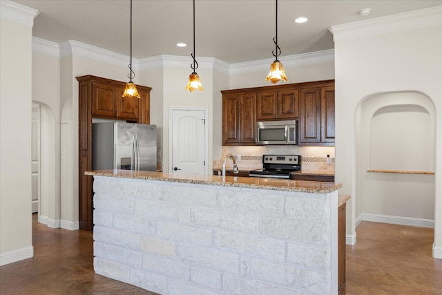 kitchen featuring decorative light fixtures, light stone counters, a kitchen island with sink, and appliances with stainless steel finishes