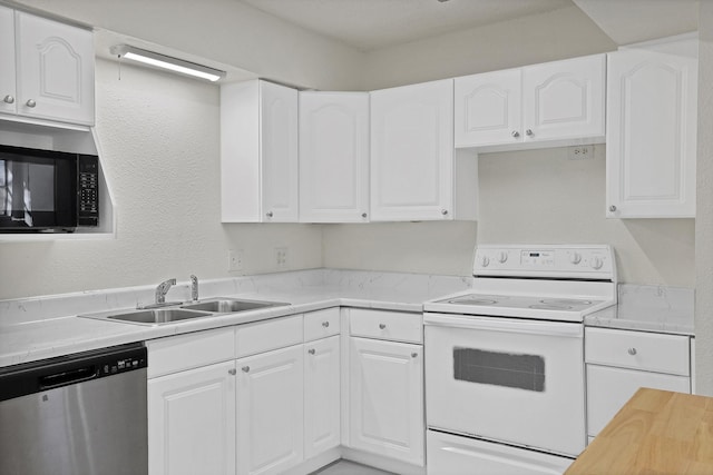 kitchen with white electric stove, stainless steel dishwasher, and white cabinets