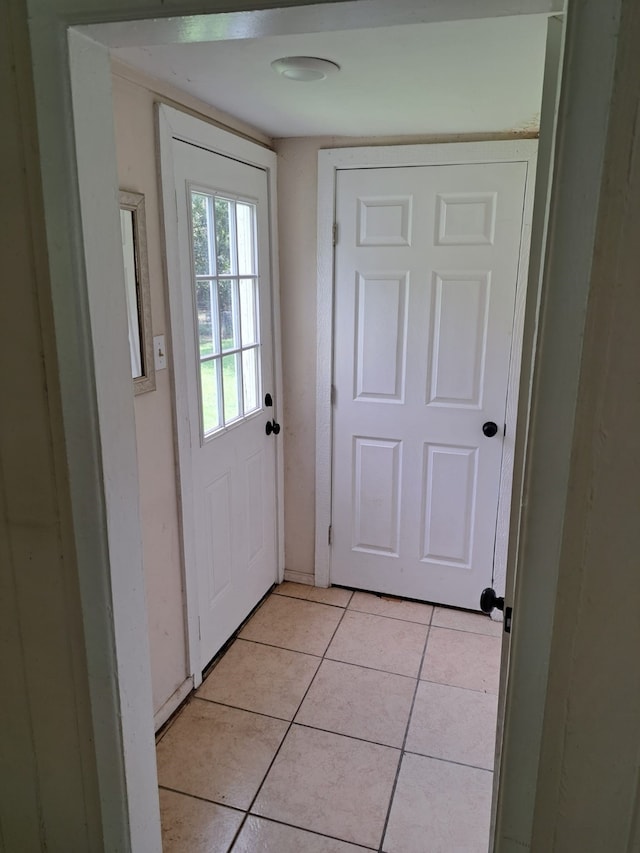 doorway with light tile patterned floors