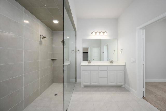 bathroom featuring tiled shower and vanity