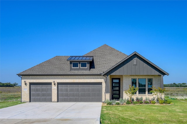 view of front of house with a garage and a front lawn