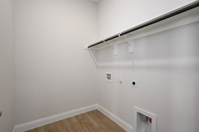 laundry area with electric dryer hookup, hookup for a gas dryer, washer hookup, and hardwood / wood-style flooring