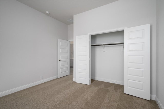 unfurnished bedroom featuring a closet and carpet floors