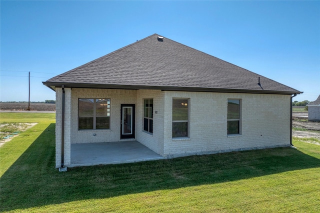 back of house featuring a yard and a patio