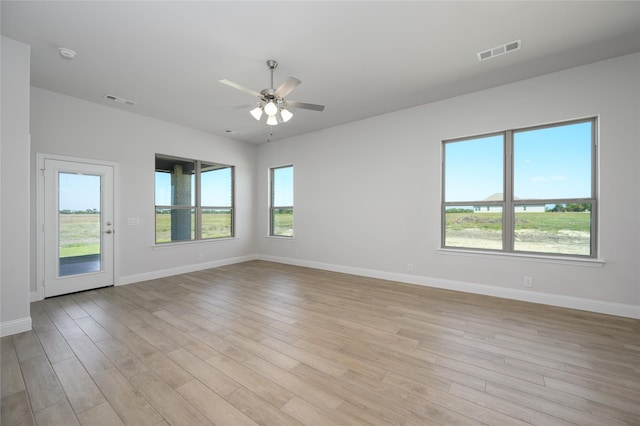 spare room featuring light hardwood / wood-style floors and ceiling fan