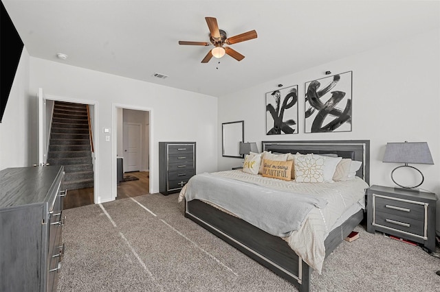 bedroom with ceiling fan and dark carpet