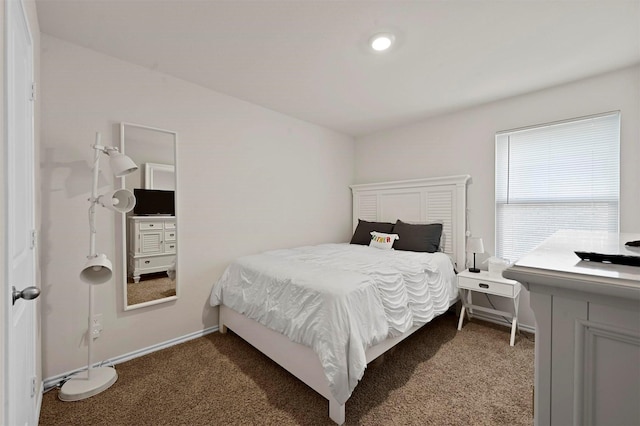 bedroom with dark colored carpet