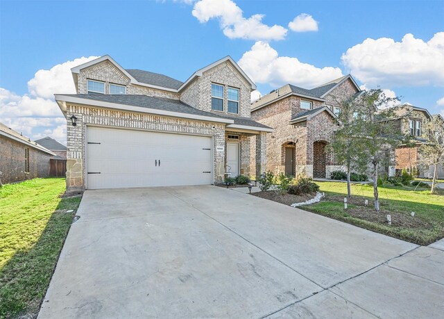 view of front of home featuring a garage and a front lawn