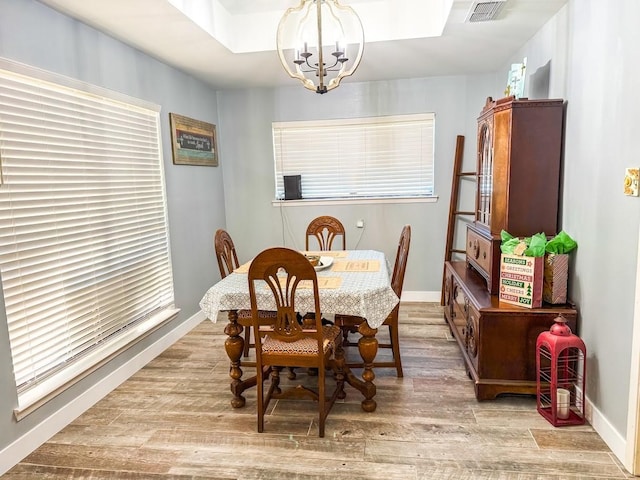 dining room featuring an inviting chandelier and light hardwood / wood-style floors