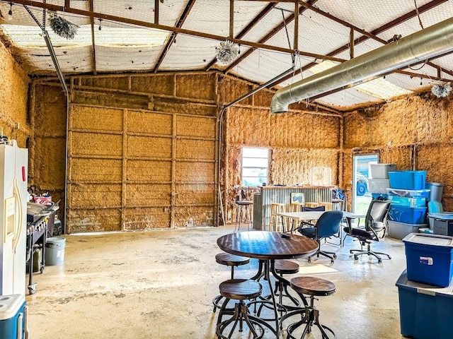 garage featuring white fridge with ice dispenser