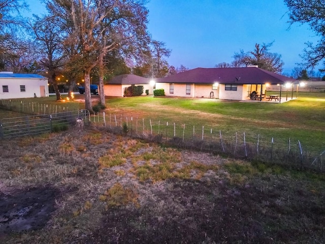 yard at dusk with a patio area