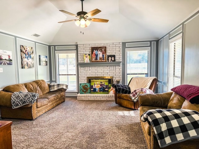 living room with vaulted ceiling, a brick fireplace, carpet flooring, and a healthy amount of sunlight