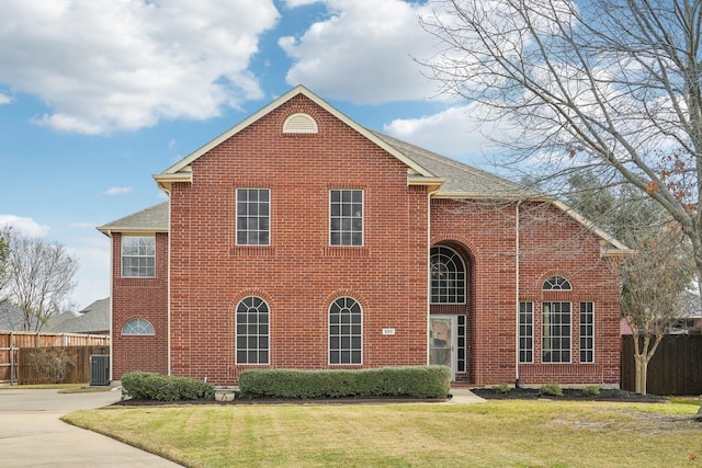 front facade with central AC and a front yard