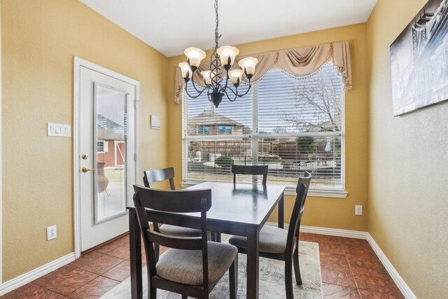 tiled dining space with plenty of natural light and a notable chandelier