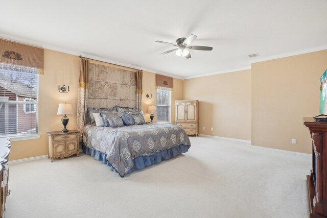 carpeted bedroom featuring ceiling fan and ornamental molding