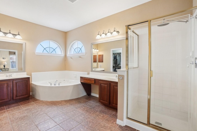 bathroom with vanity and shower with separate bathtub