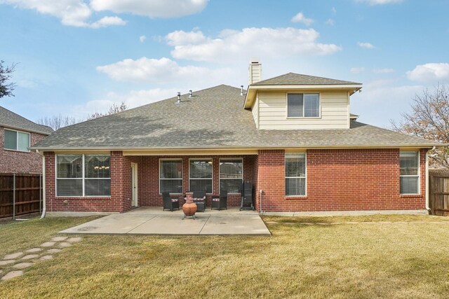 rear view of property featuring a patio area and a yard