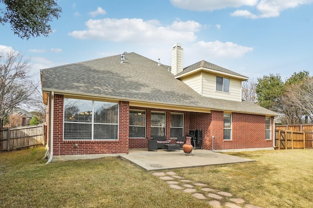 back of house with a lawn and a patio area