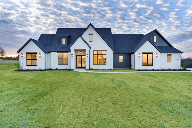 modern inspired farmhouse with a lawn and french doors