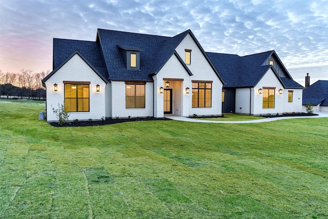 modern inspired farmhouse featuring a lawn