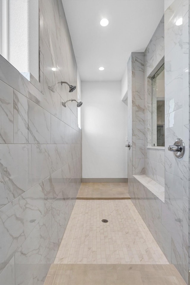 bathroom featuring tiled shower and tile patterned floors