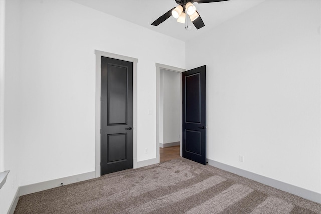 unfurnished bedroom with ceiling fan and carpet