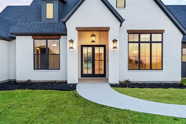 doorway to property with a yard and french doors