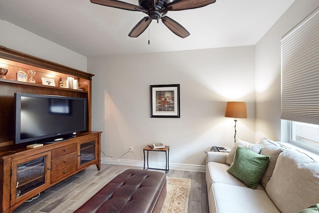 living room featuring ceiling fan and hardwood / wood-style flooring