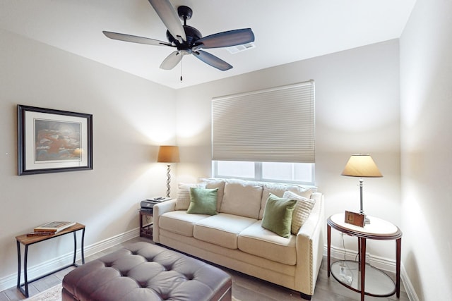 living room with wood-type flooring and ceiling fan