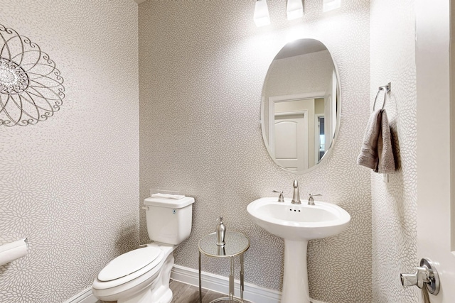 bathroom featuring wood-type flooring and toilet