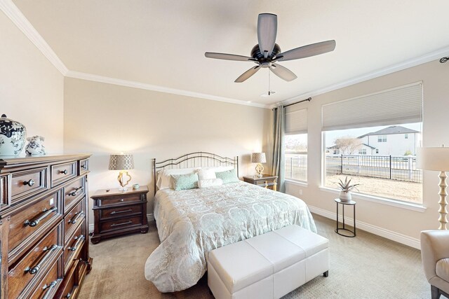 carpeted bedroom with ceiling fan and crown molding