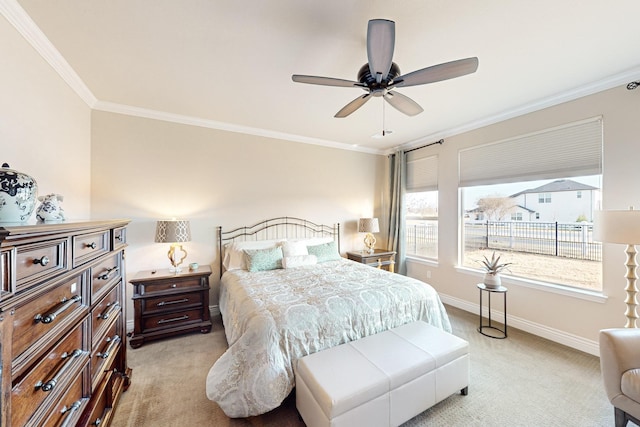 bedroom with light carpet, ornamental molding, and ceiling fan