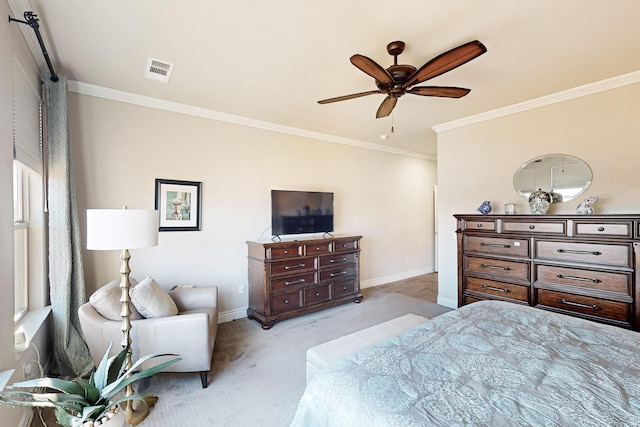 carpeted bedroom with ceiling fan and ornamental molding