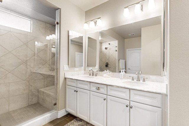 bathroom featuring vanity and tiled shower