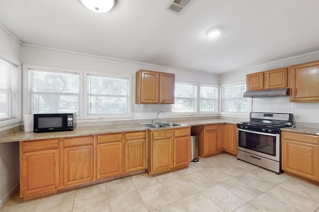 kitchen featuring light stone counters, ornamental molding, sink, and stainless steel stove