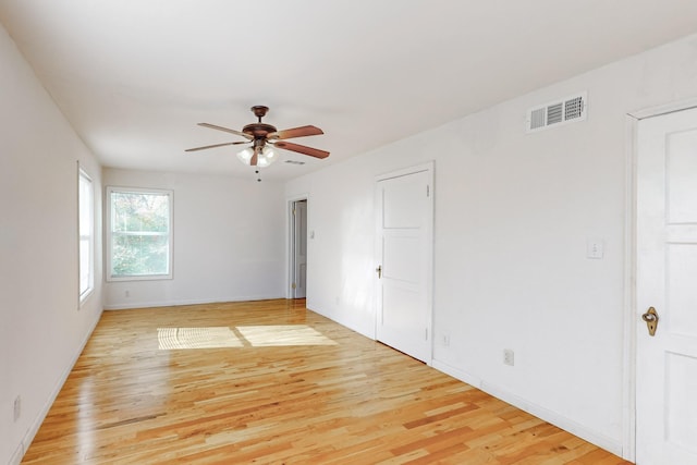 empty room with light hardwood / wood-style floors and ceiling fan