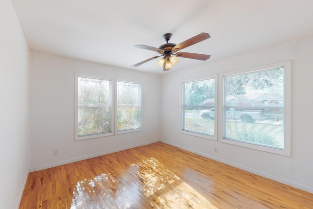 spare room featuring ceiling fan, plenty of natural light, and light wood-type flooring