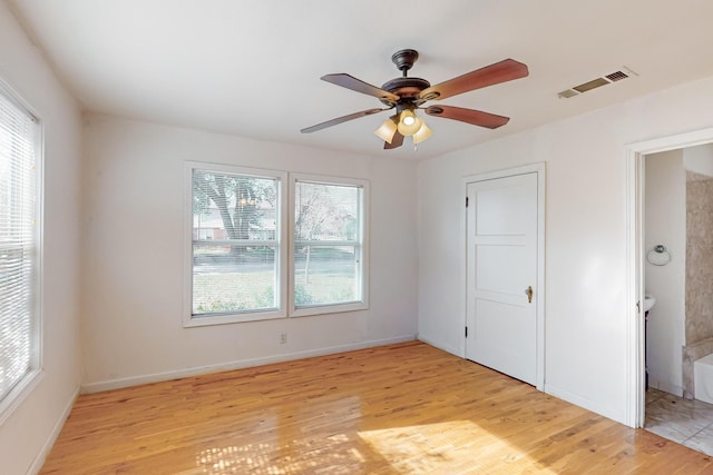 empty room featuring ceiling fan and light wood-type flooring