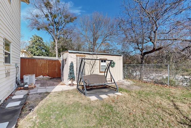 view of outdoor structure featuring central AC and a lawn