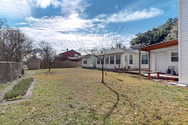 view of yard with a shed and a deck