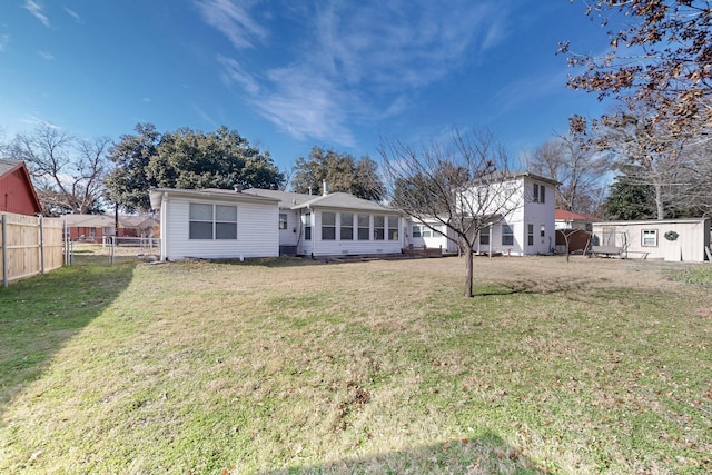 rear view of house with a lawn