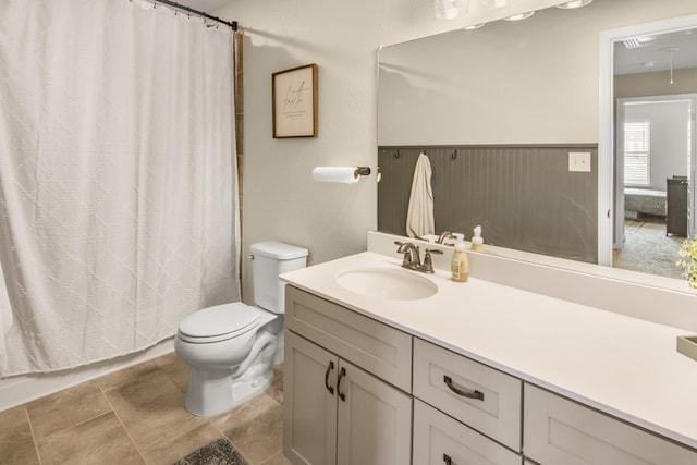 bathroom featuring walk in shower, vanity, and toilet