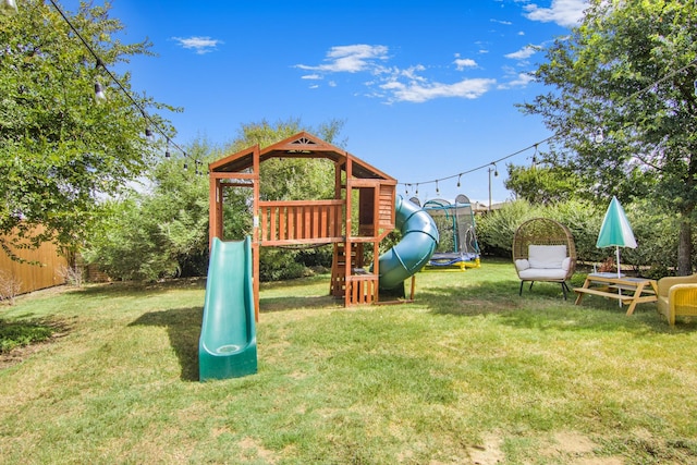 view of play area featuring a lawn and a trampoline